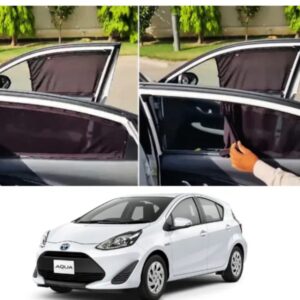 Black fabric car window curtains installed on a white Toyota Aqua in Pakistan for sun protection